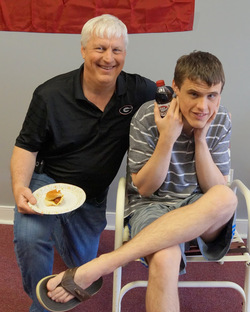 Scott Ballard sitting next to a boy